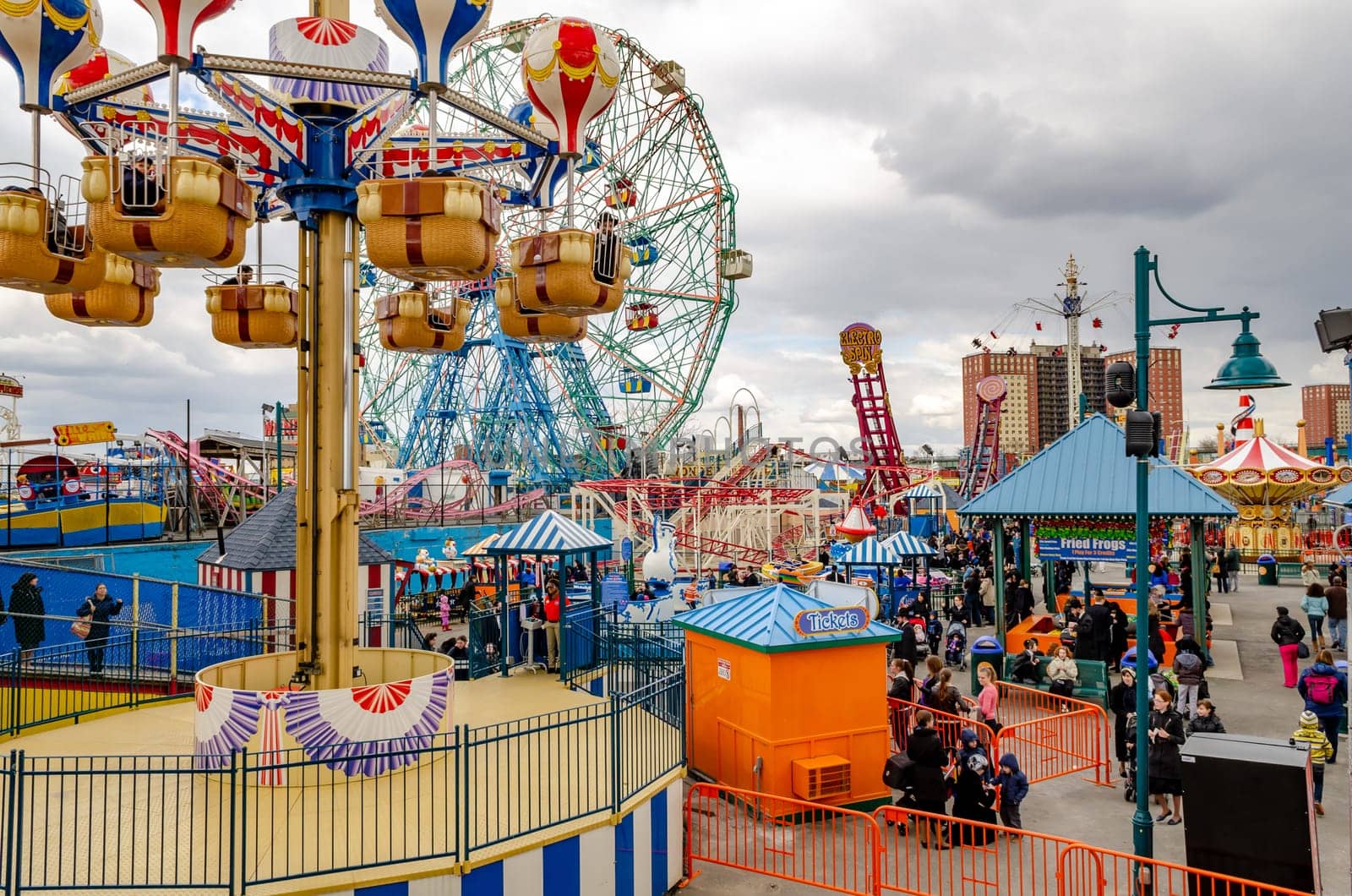 Different Rides at Luna Park Amusement Park, Coney island, aerial view, Brooklyn, crowd of People at Jewish National Day, New York City during winter day with cloudy sky, horizontal
