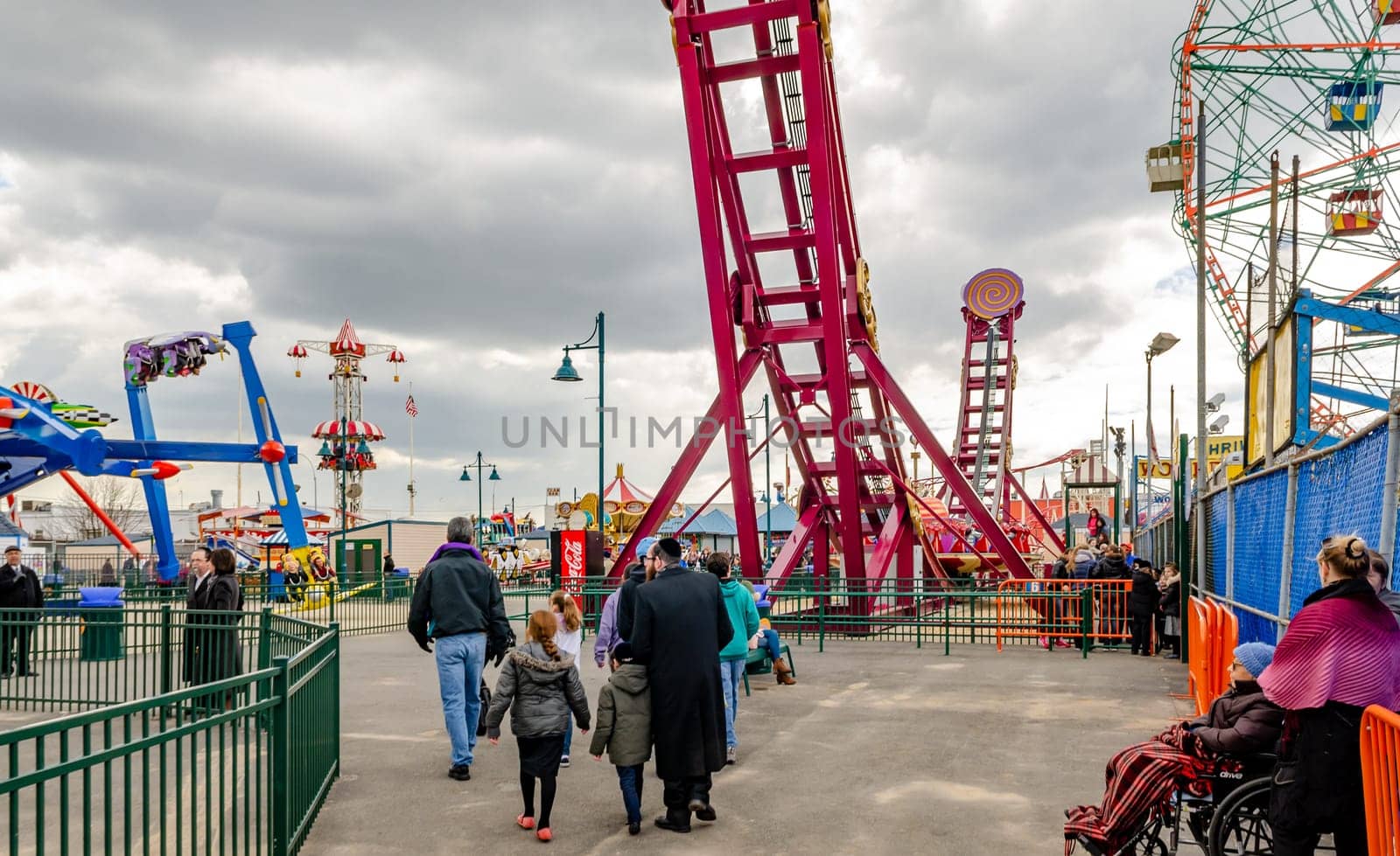 Jewish National Day, different Rides at Luna Park Amusement Park, Coney island, Brooklyn, People walking and standing in front, New York City during winter day with cloudy sky, horizontal
