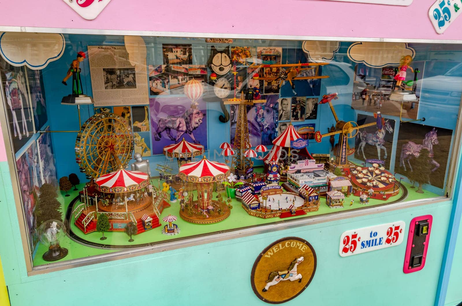 Retro Old vending machine at Luna Park Amusement Park, Coney island, Brooklyn with different miniature Rides visible through a window, New York City during winter day, horizontal