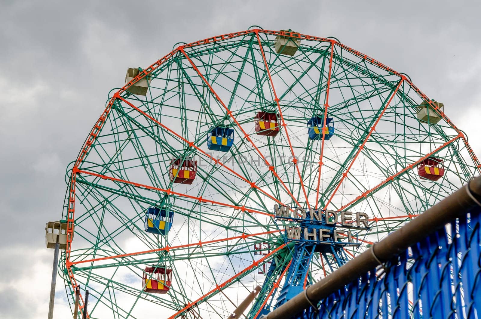Wonder Wheel Ferris Wheel at Luna Park Amusement Park, Coney island, Brooklyn, view from low angle, New York City during winter day with cloudy sky, horizontal