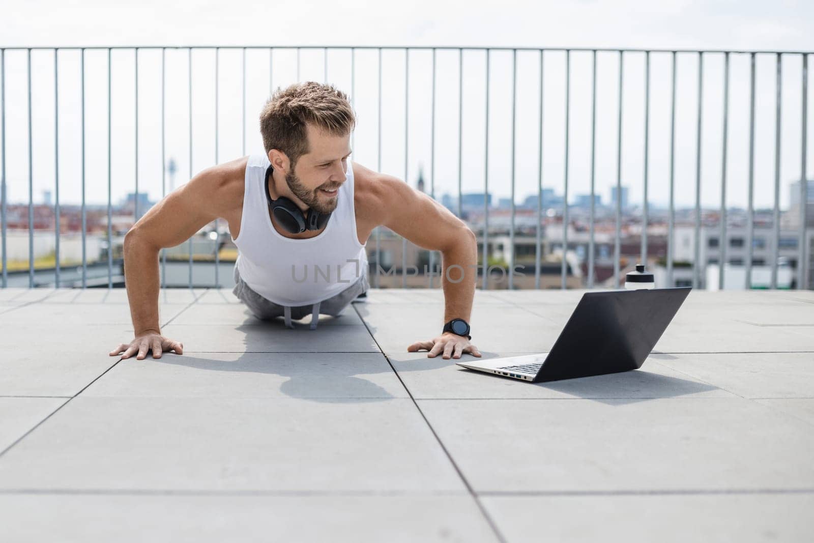 Handsome young man training and working out outdoors