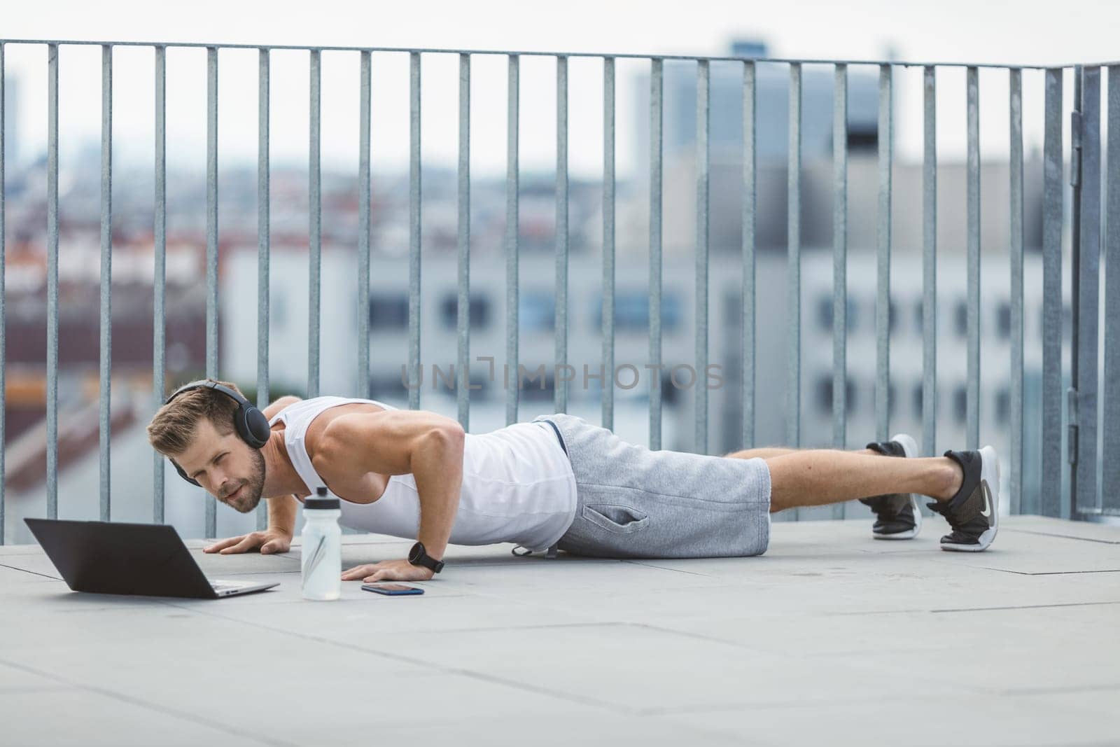 Handsome young man training and working out outdoors