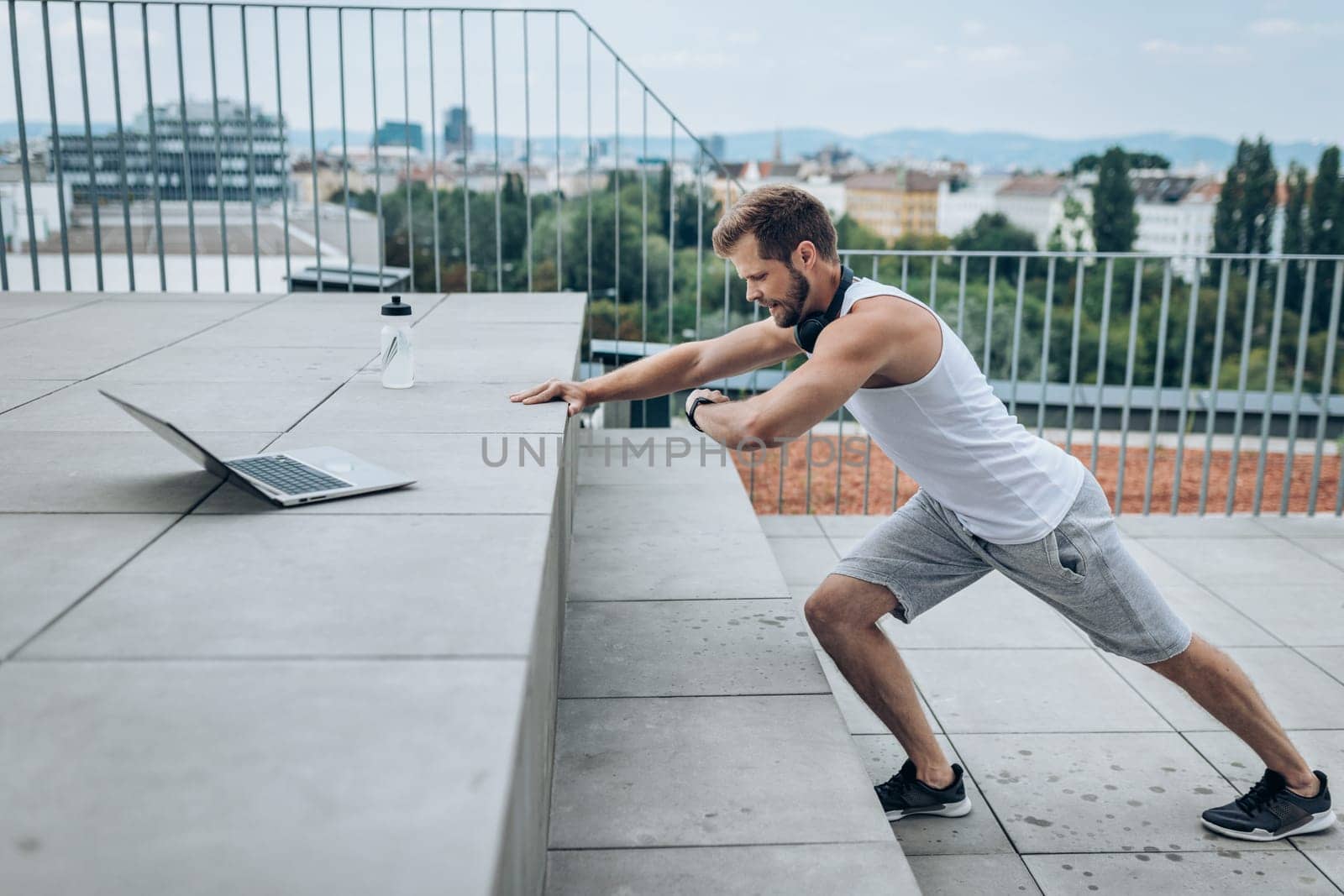 Handsome young man training and working out outdoors