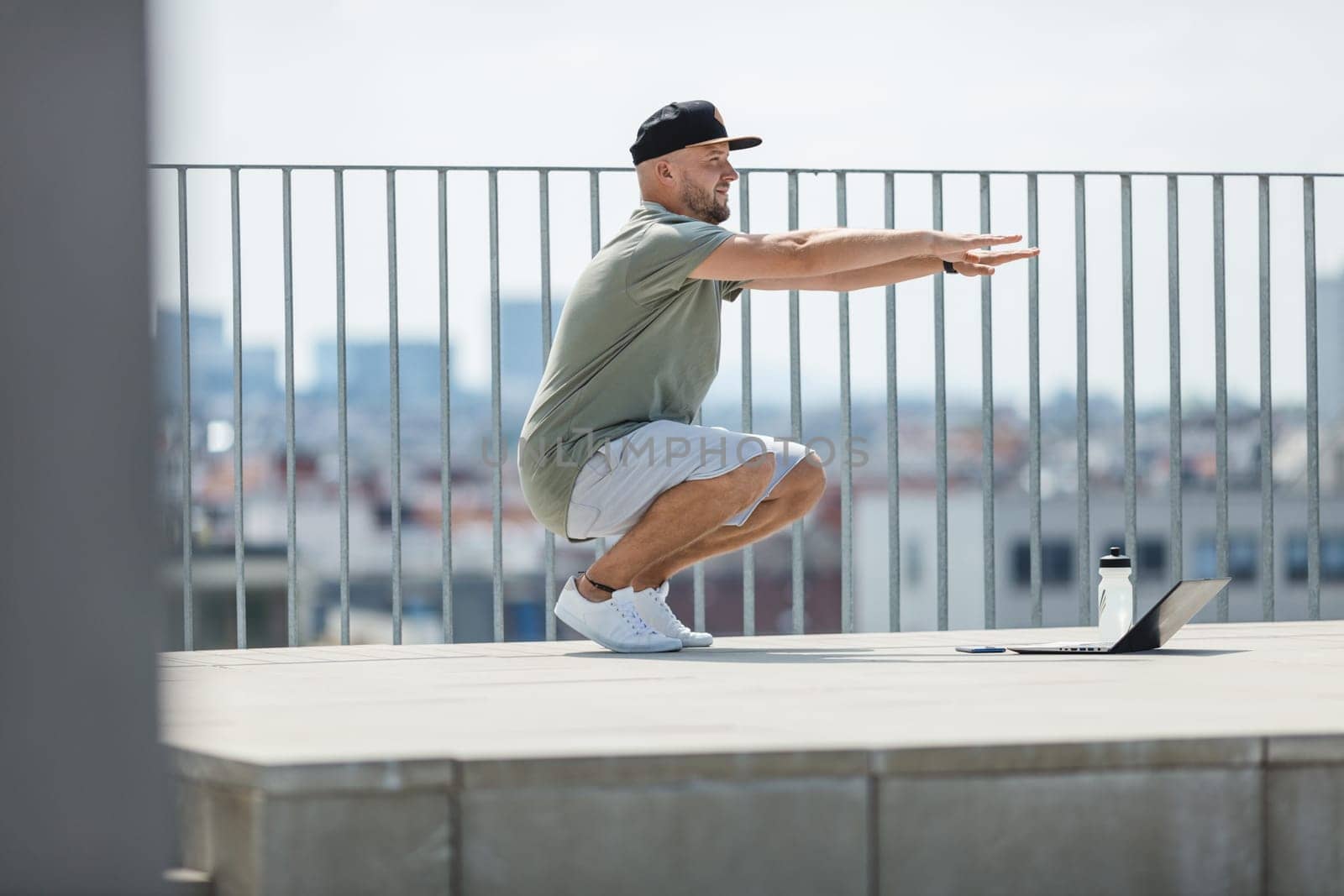 Handsome young man training and working out outdoors