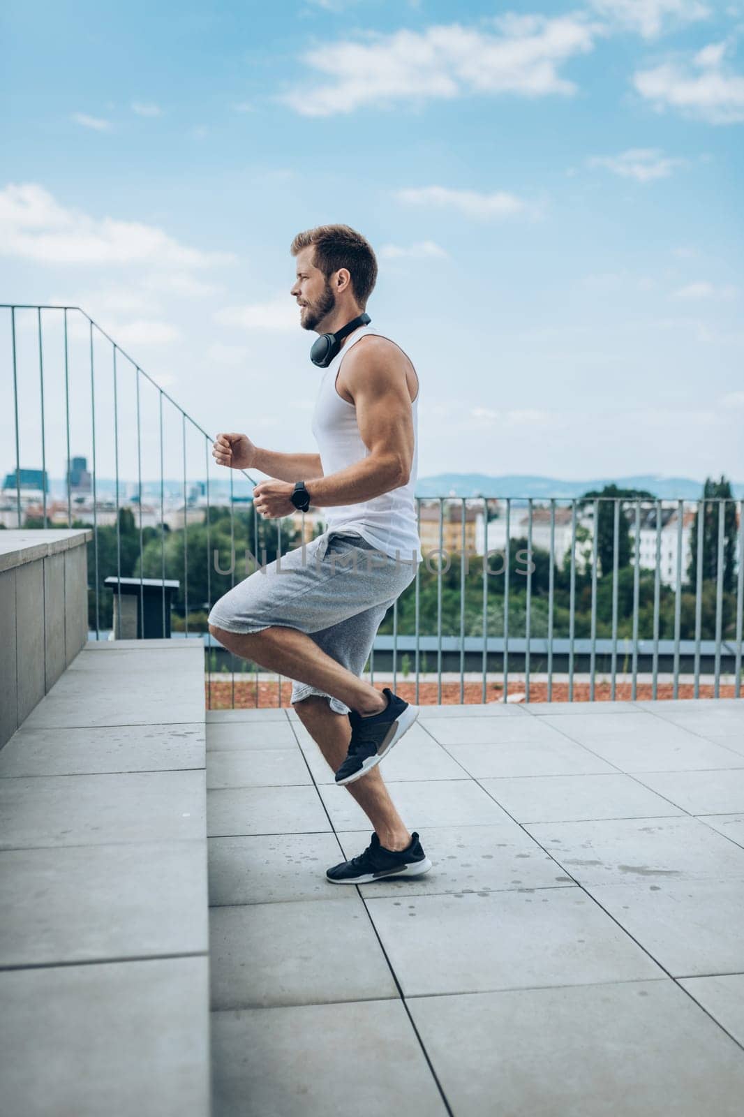 Handsome young man training and working out outdoors