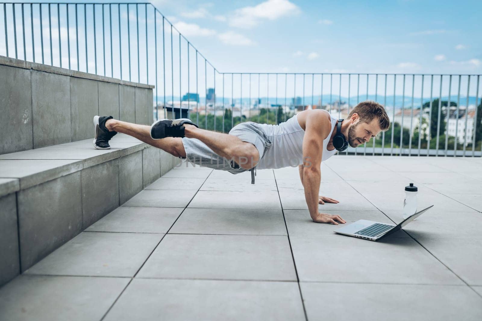 Handsome young man training and working out outdoors