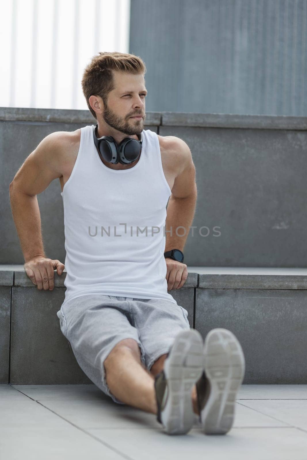 Handsome young man training and working out outdoors