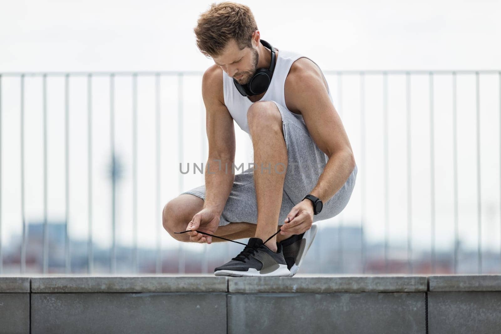 Handsome young man training and working out outdoors