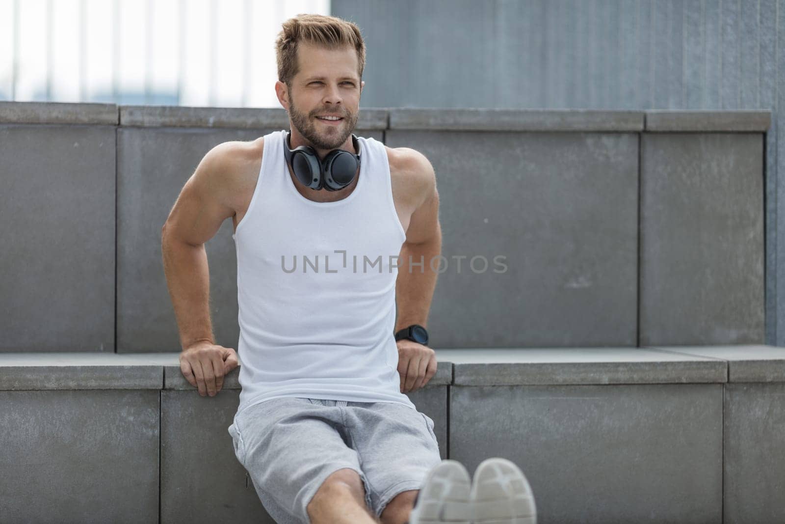 Handsome young man training and working out outdoors