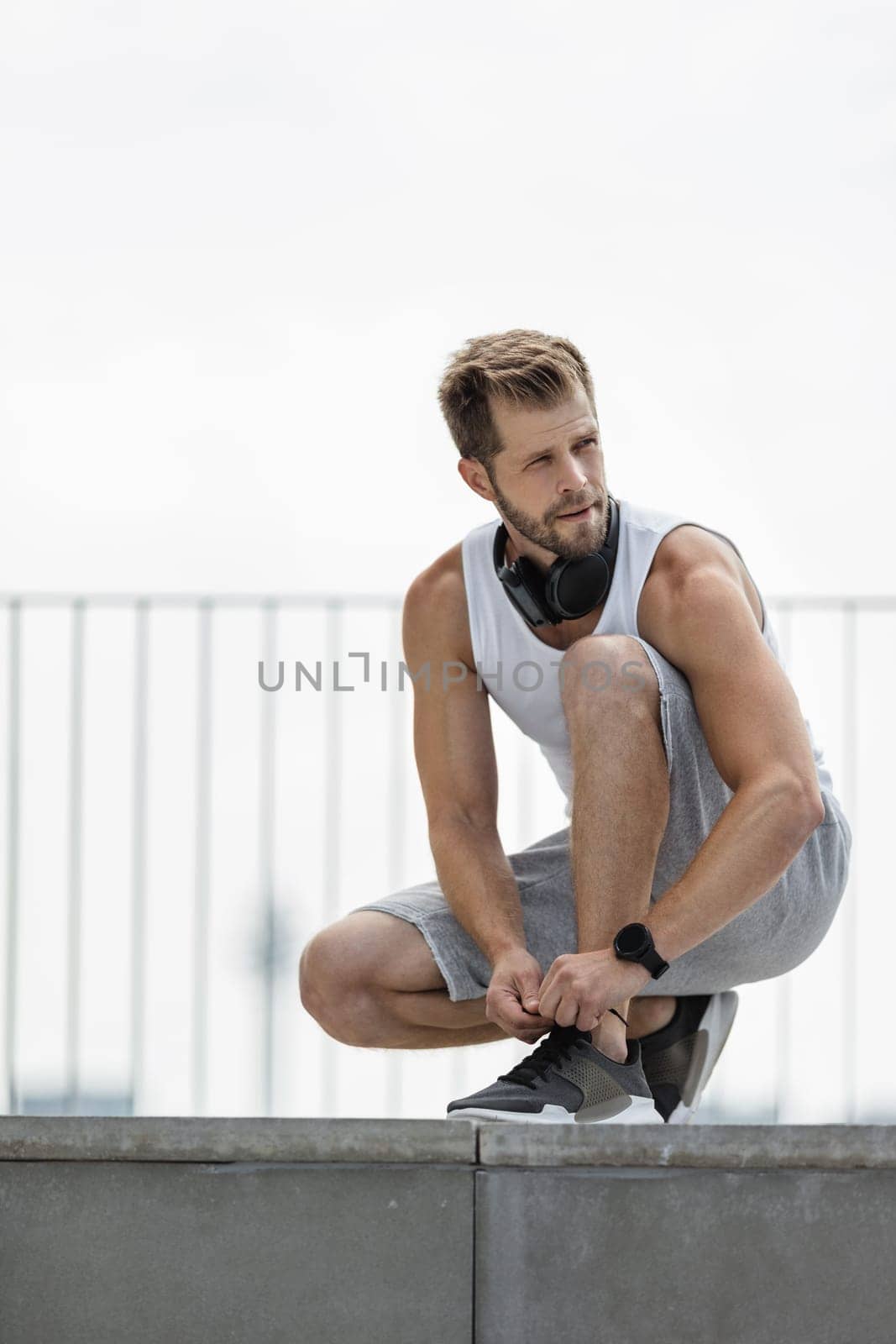 Handsome young man training and working out outdoors