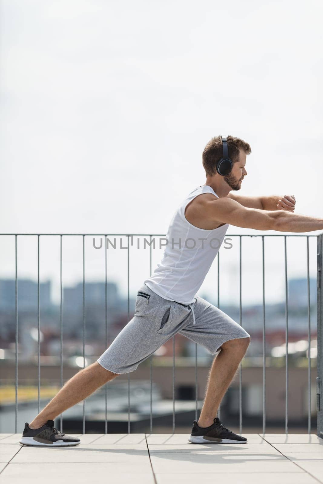 Handsome young man training and working out outdoors