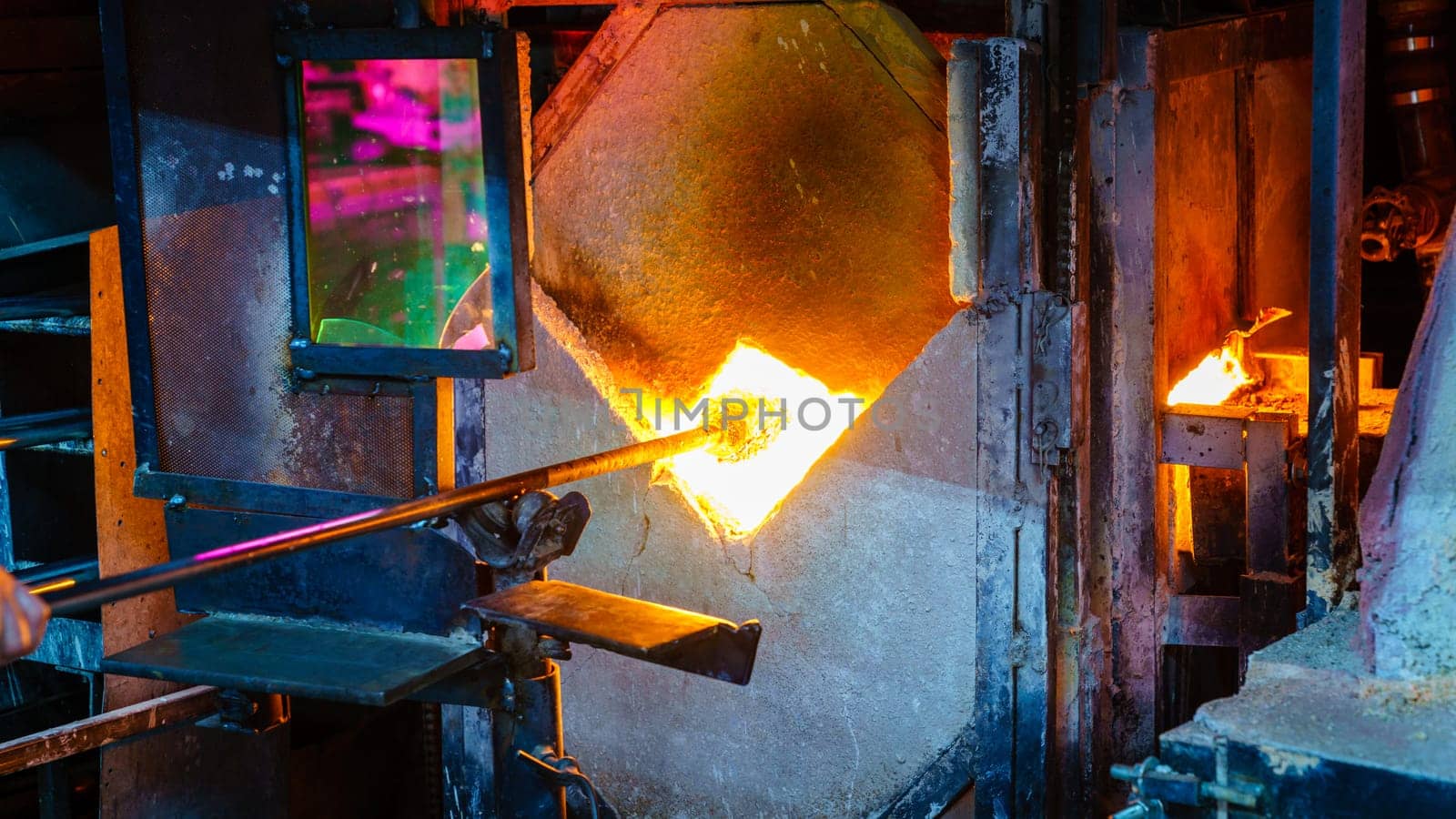Softening glass in a kiln during glassblowing process