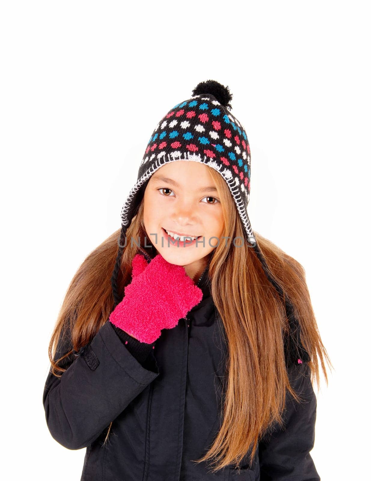 A closeup picture of a young girl with long blond hair, a hat and mittens,.standing isolated for white background..