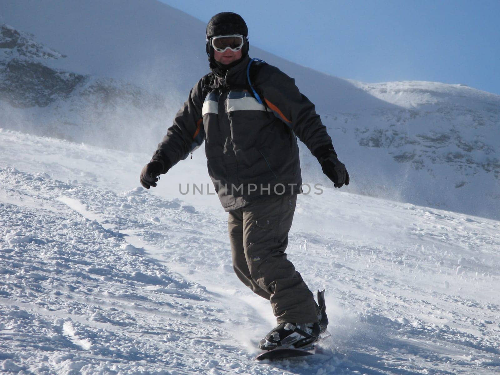 snowboarder on a ski slope under a blue sky