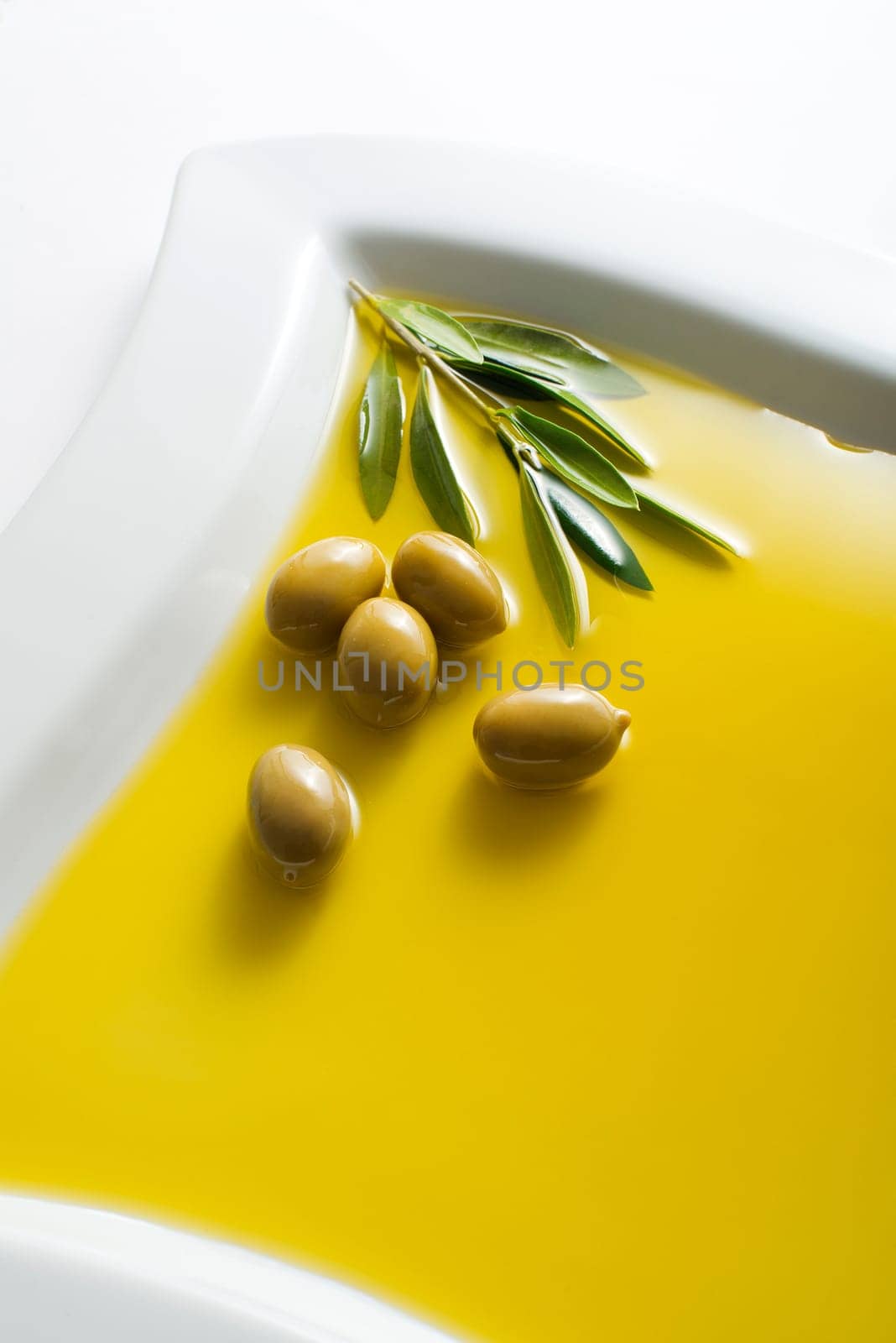 Olive fruit in oil background close up