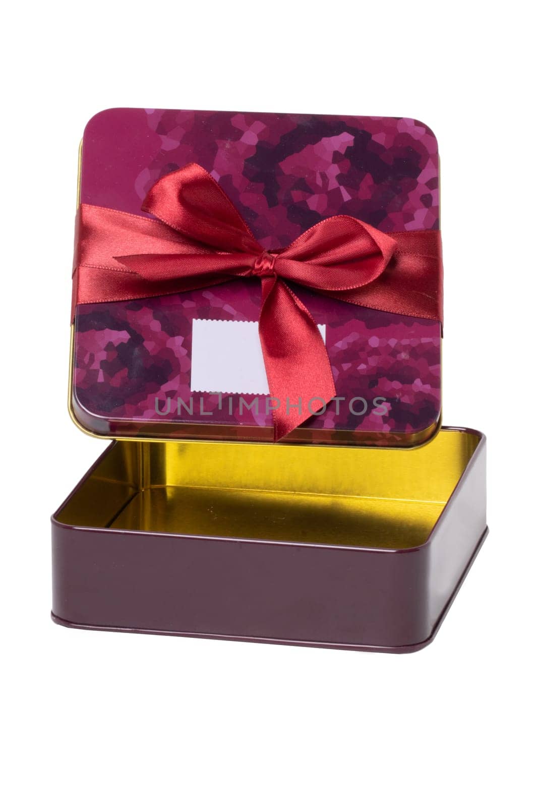 Closeup of a decorative opened red pink present or gift box with ribbon bow isolated on a white background. Birthday, Christmas, Valentine's Day. Macro.