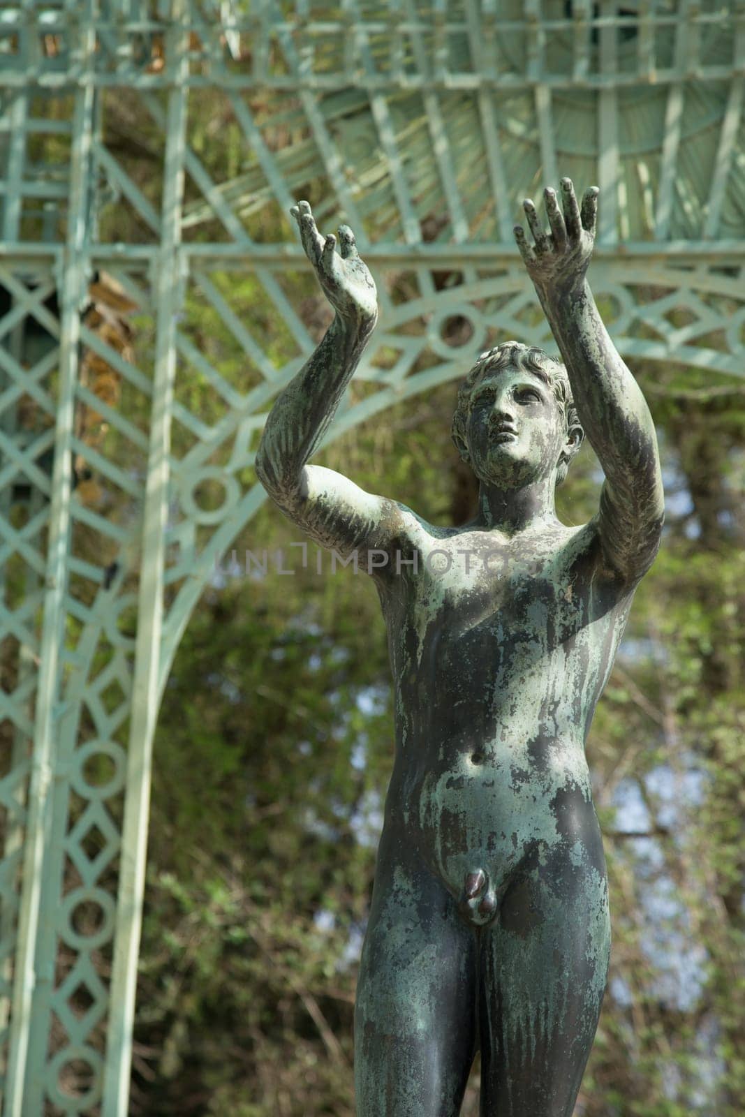 Statue of a youth in front of a pavilion in the park of Sans Souci Palace