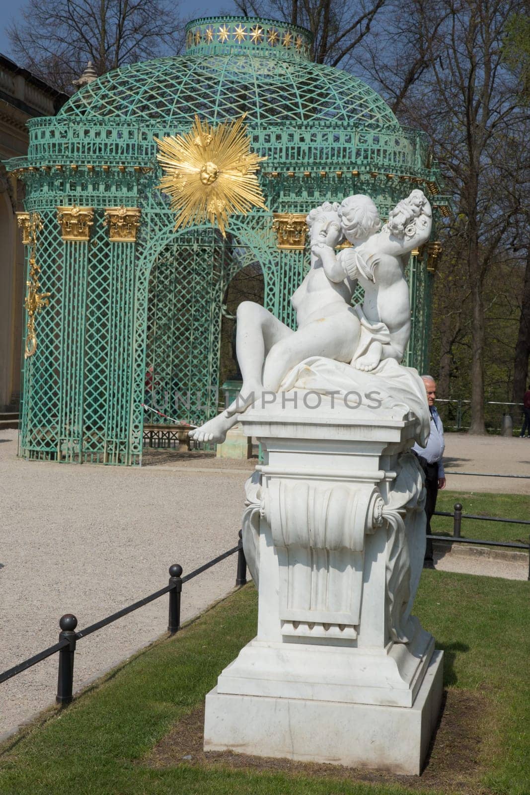 Statue of woman and angel in front of the pavilion in Park Sans Souci Potsdam