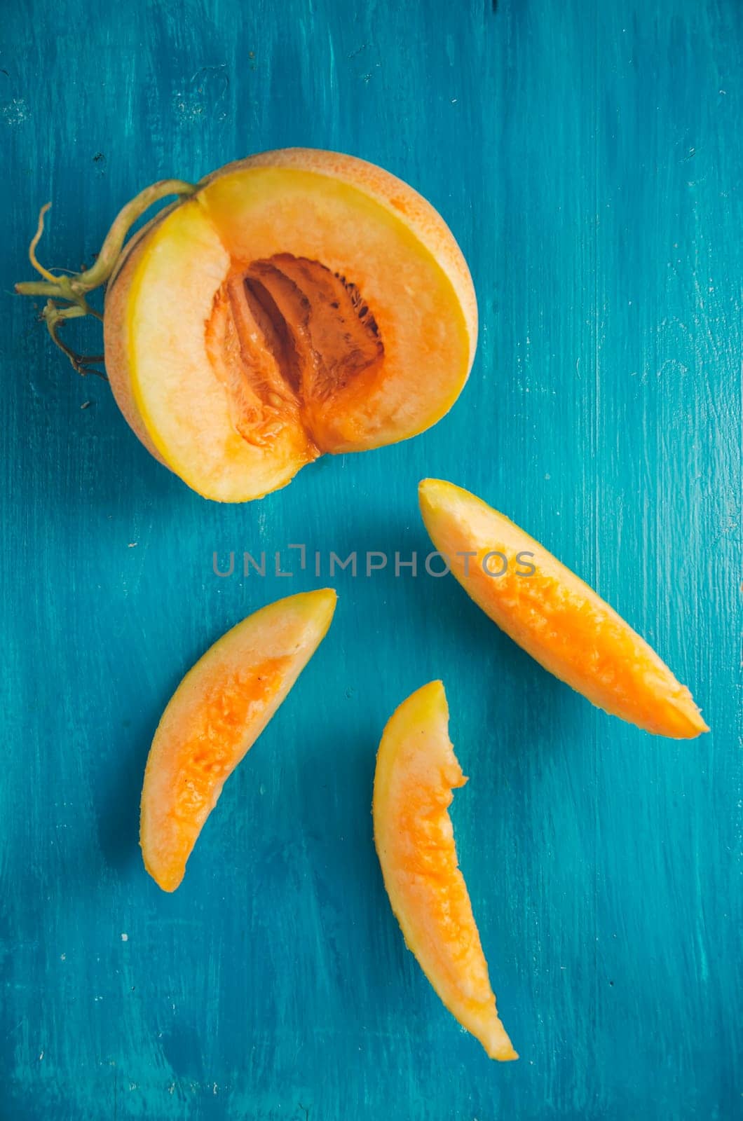 Melon slices on rustic blue background