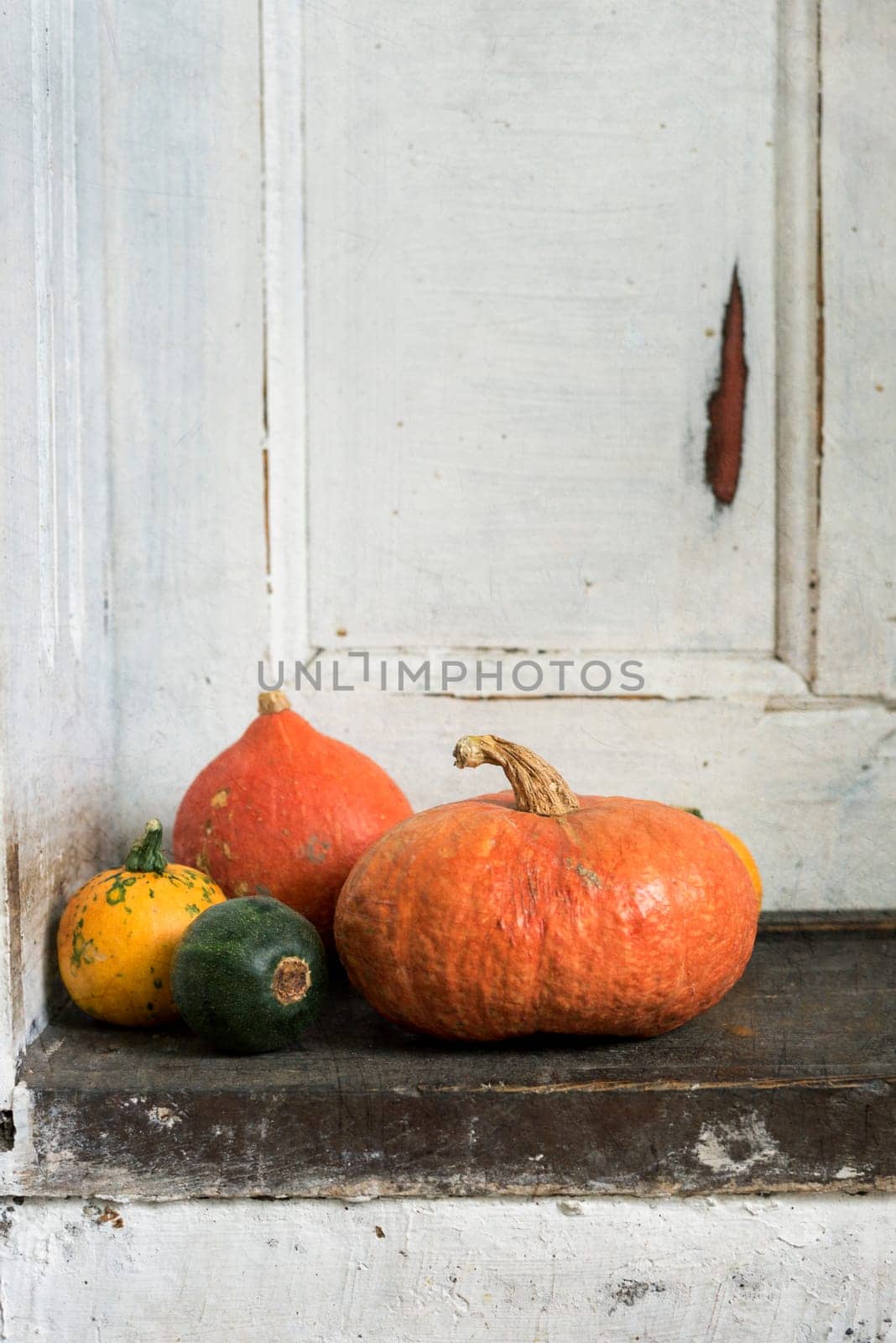 Pumpkins on the rustic wooden doorstep. Texture added.
