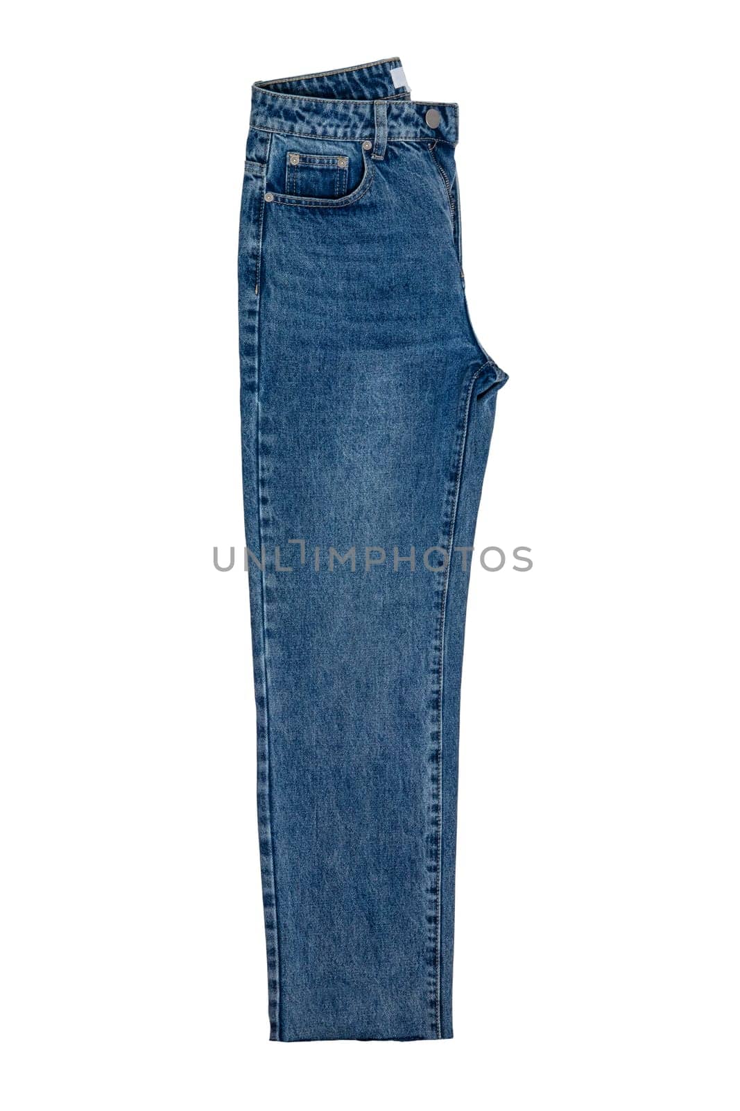 Woman jeans isolated. Folded trendy stylish female blue jeans trousers isolated on a white background. Clipping path. Fashionable denim pants for women.