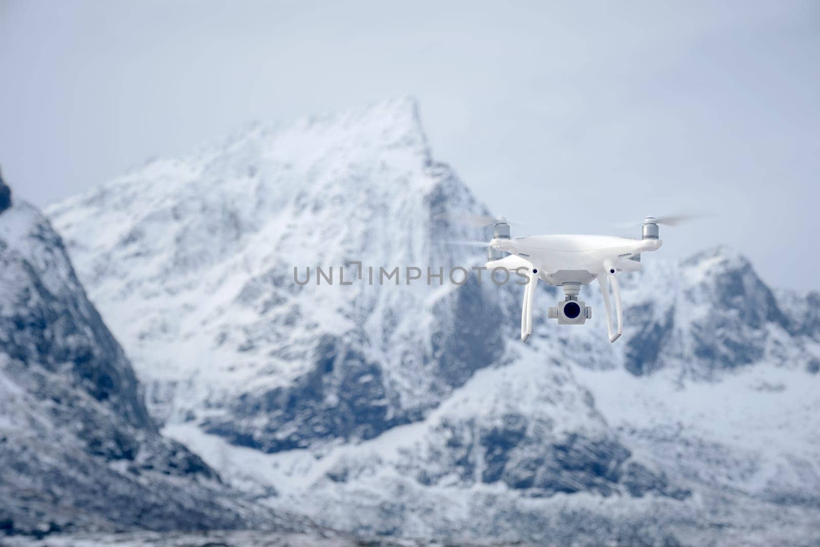 Quadcopter drone with digital camera in mountains