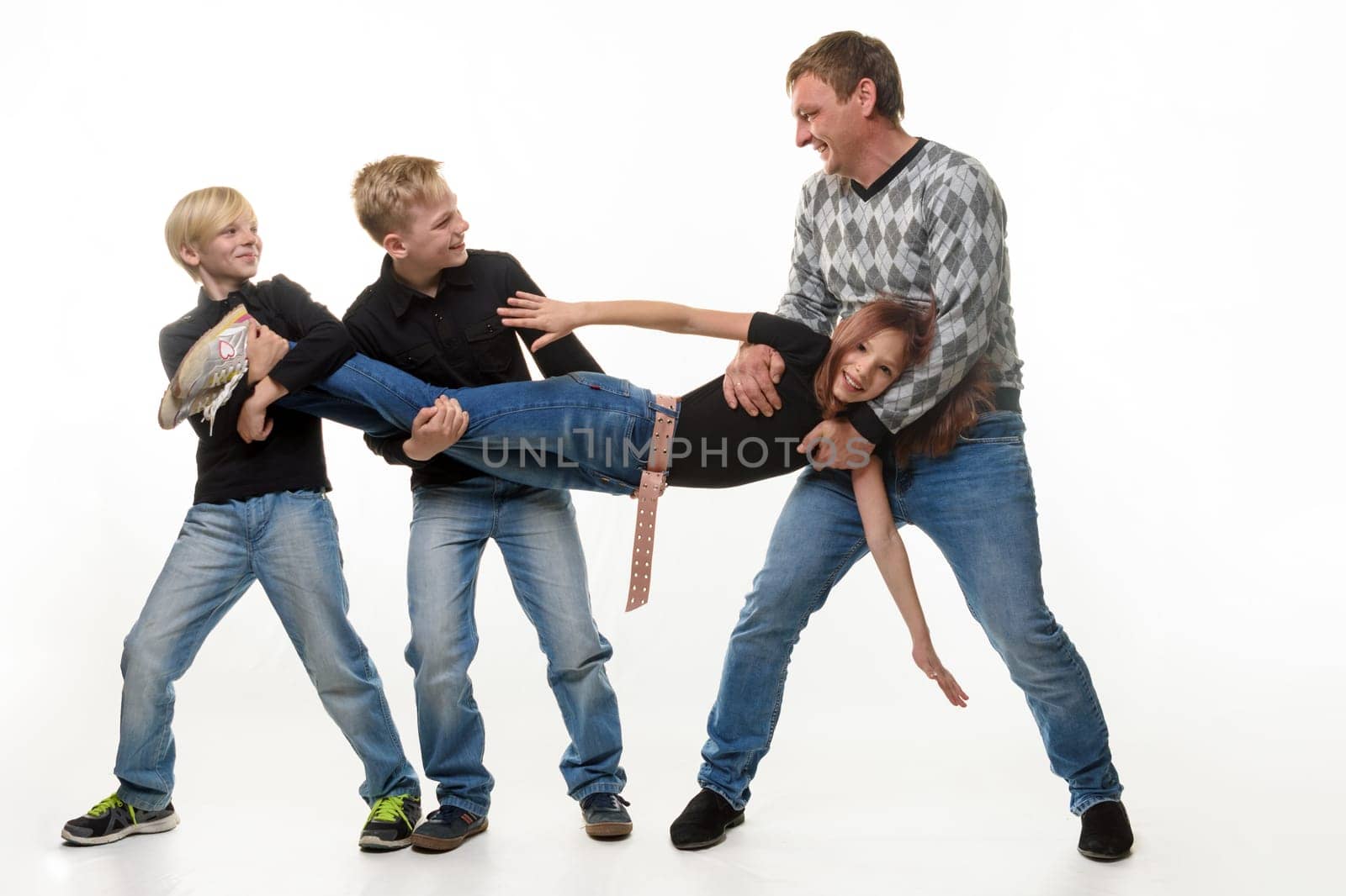 Dad and sons stretch sister by the arms and legs, white background