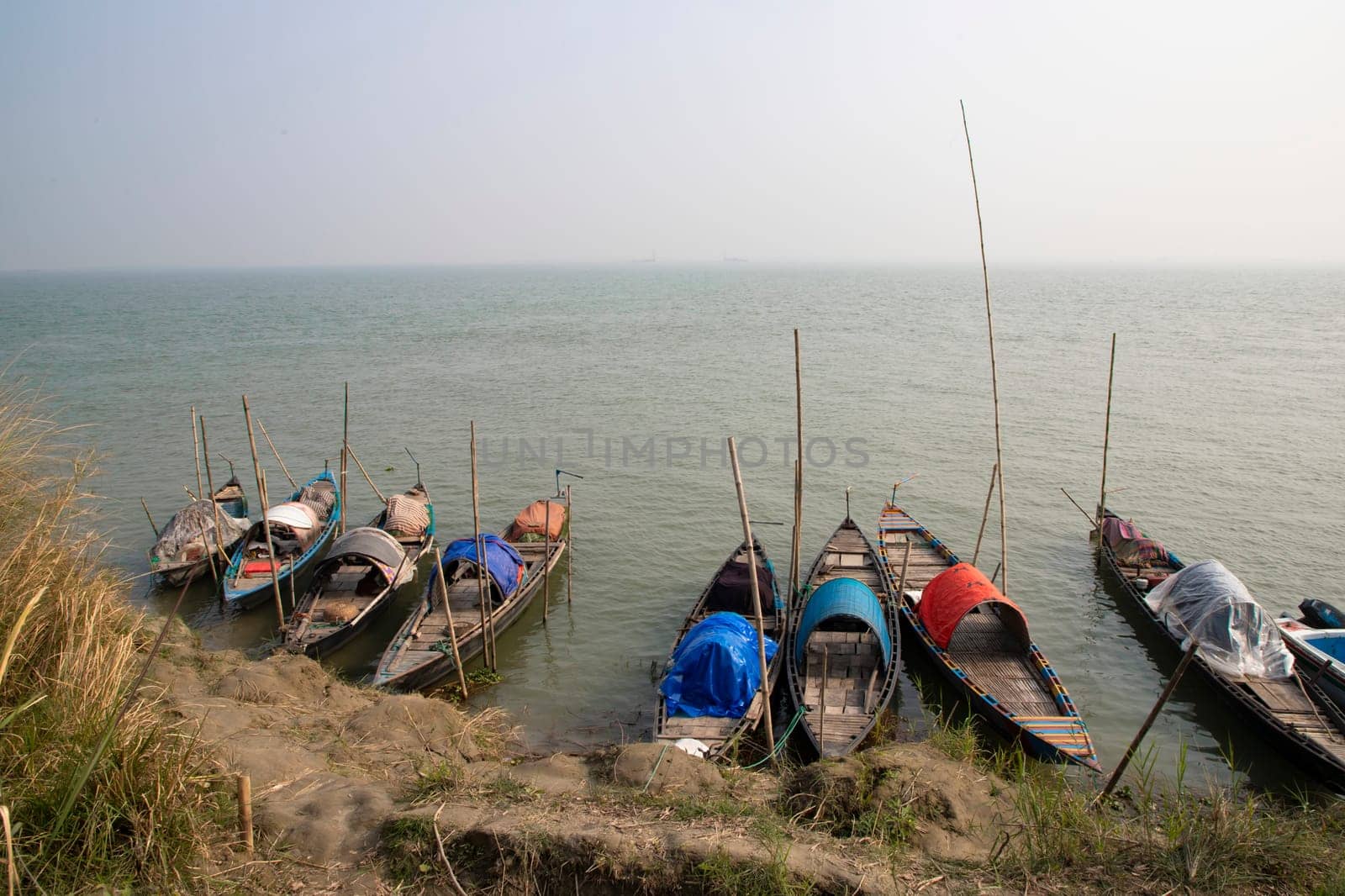 Beautiful view of Traditional Some wooden fishing boat on Padma river by Bangladesh. Natural Landscape view