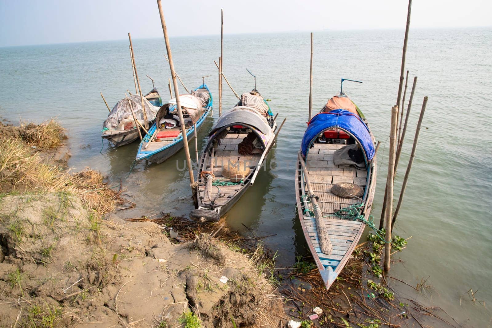 Beautiful view of Traditional Some wooden fishing boat on Padma river by Bangladesh. Natural Landscape view