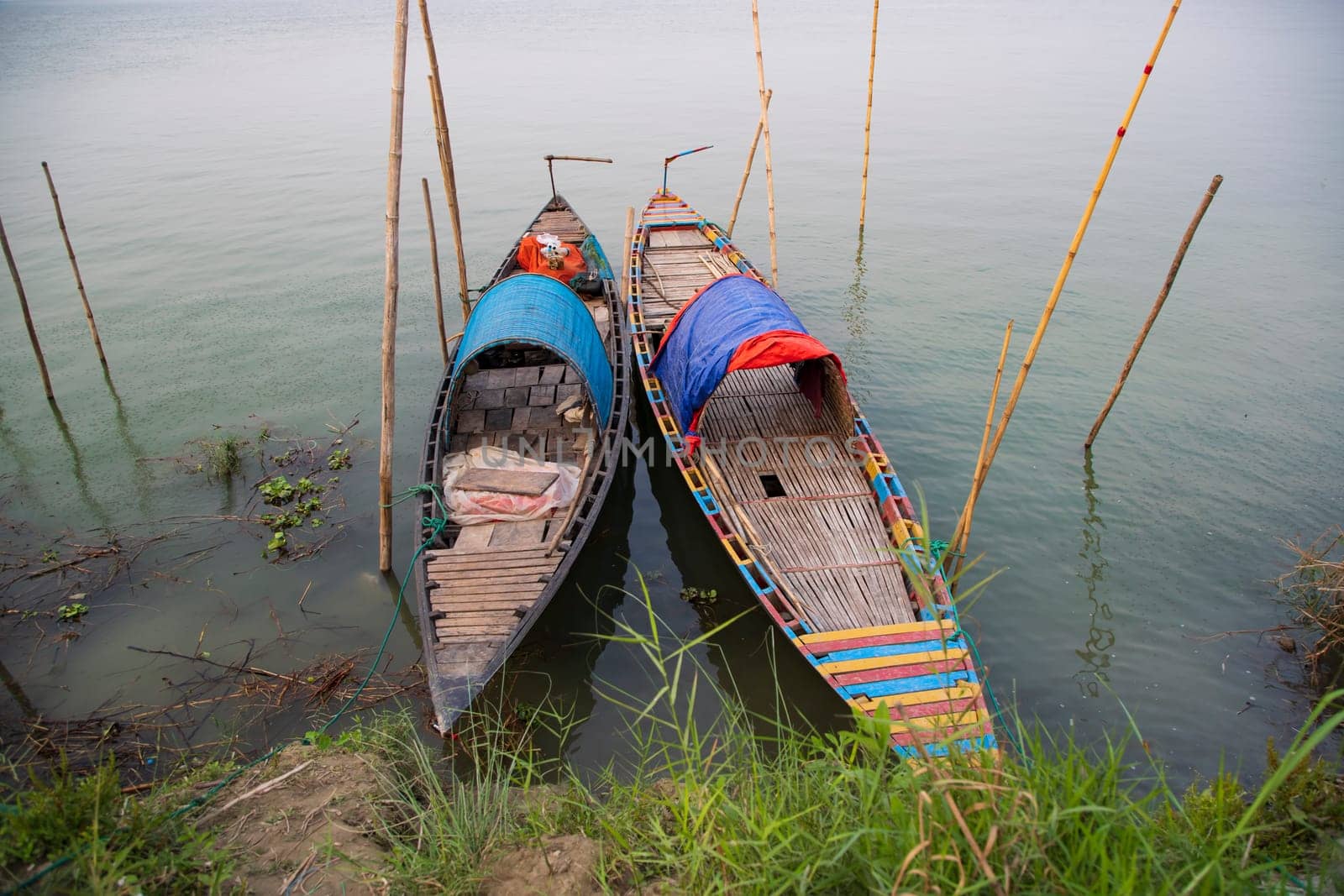 Beautiful Landscape View of Two wooden fishing boats on the bank of the Padma river in Bangladesh