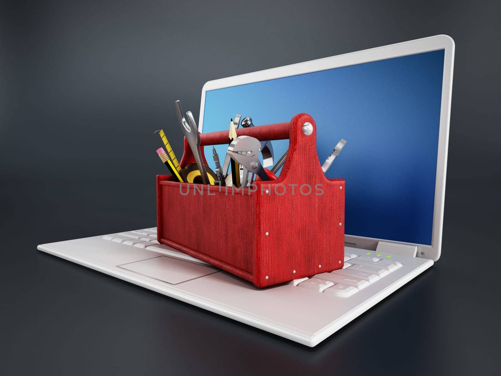 Red toolbox standing on laptop computer isolated on black background