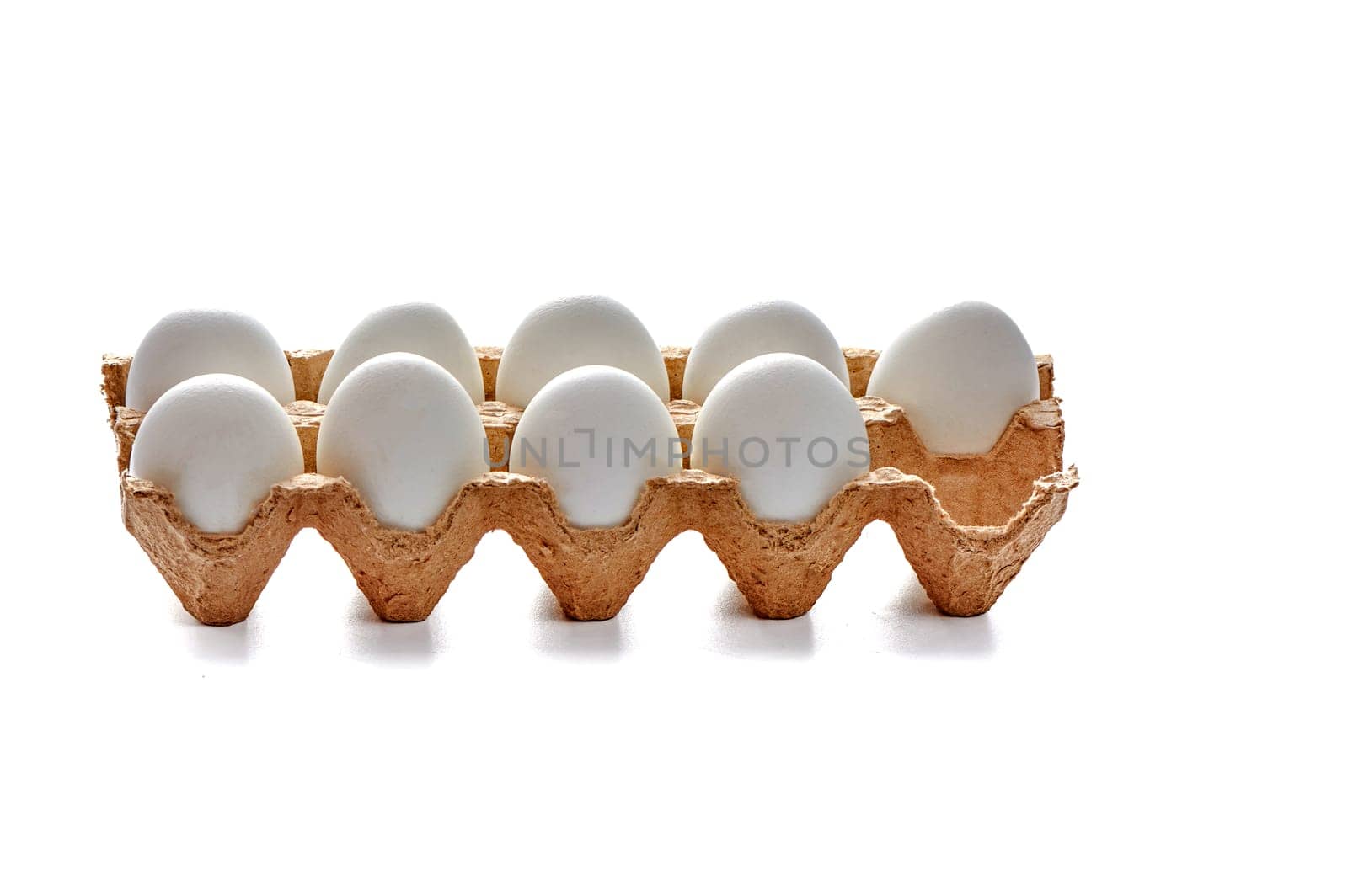 Nine white eggs on a cardboard stand on a white isolated background, copy space. High quality photo