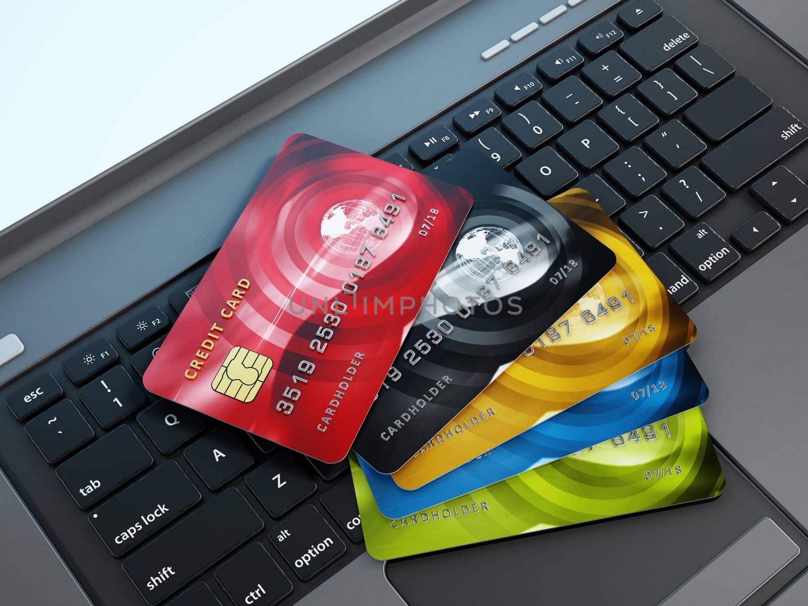 Multi colored credit card standing on laptop keyboard