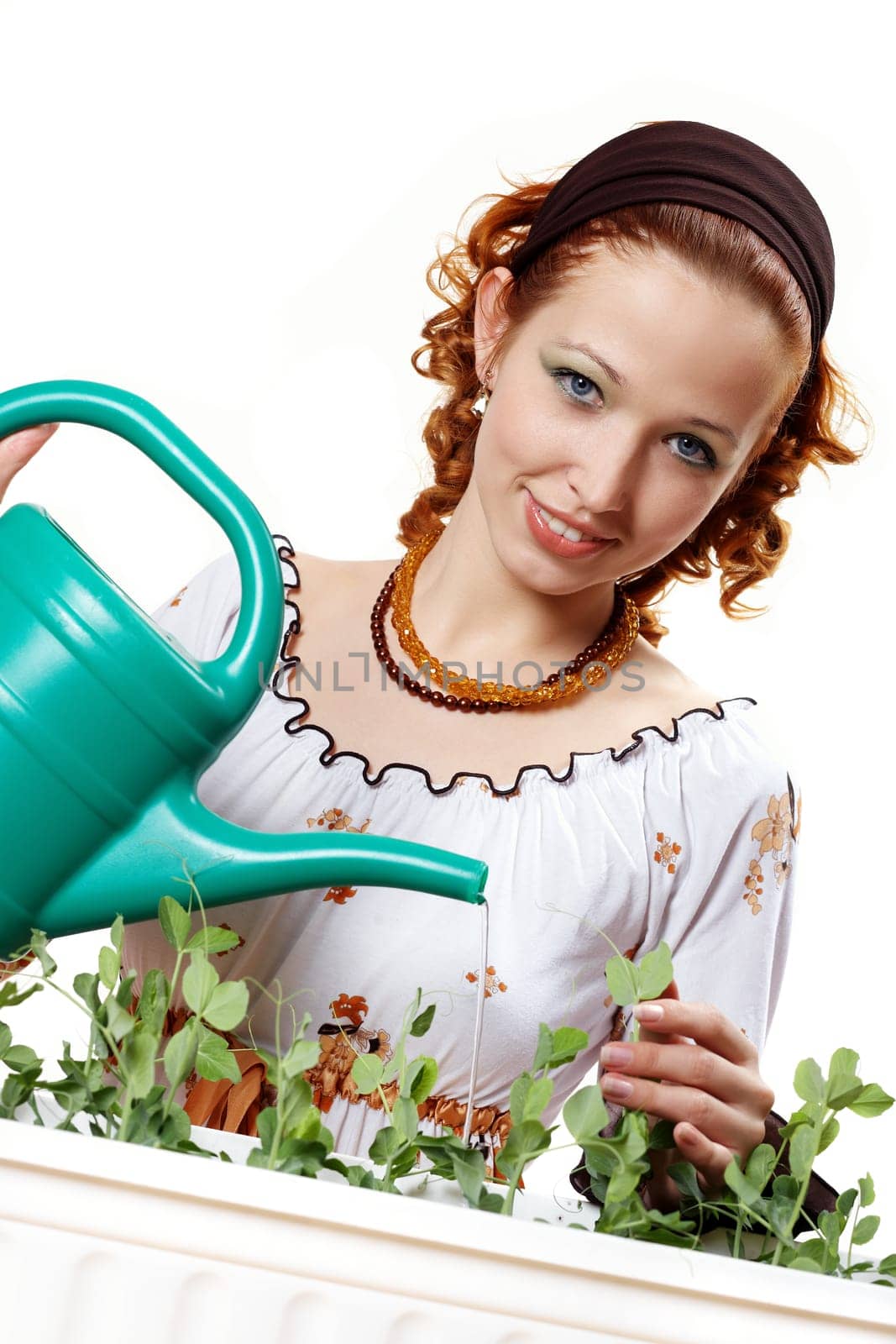 Young woman watering Erbsee I.