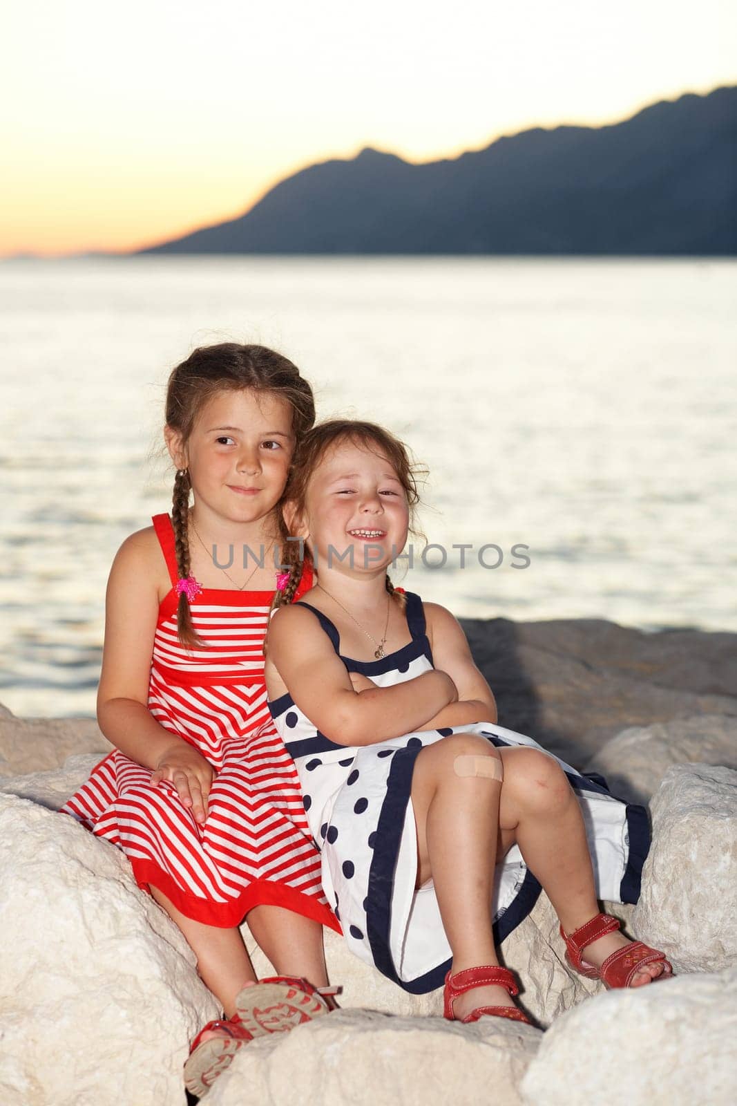 Two girls at the sea in the evening
