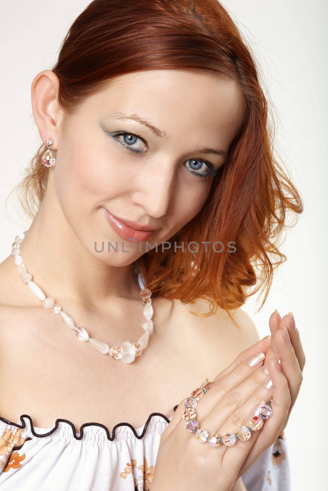Red-haired woman with white jewelry