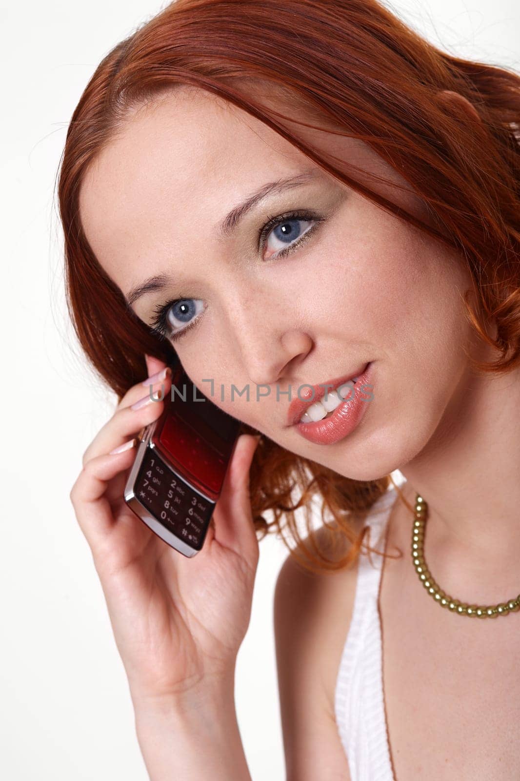 Red-haired woman makes calls from cell phone II.