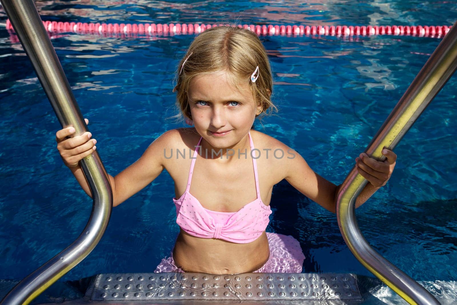 Blond girl swimming in pool II