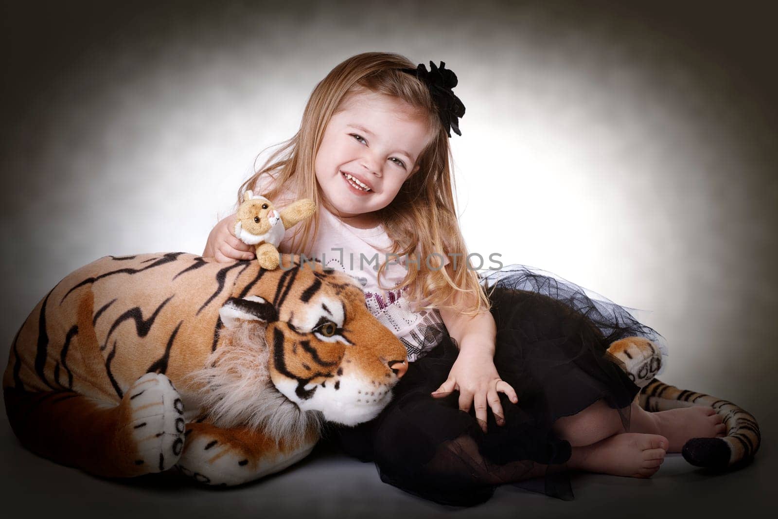 Little girl with plush tiger II