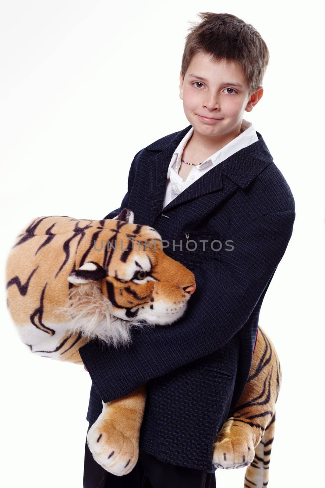Young boy wearing a suit and holding a tiger