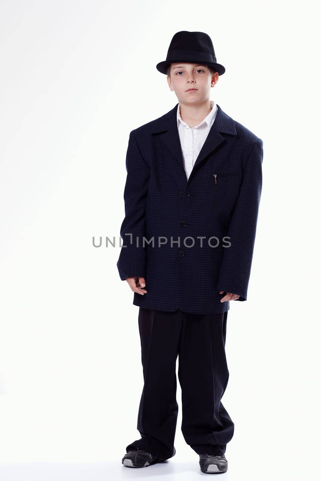 Young staying boy wearing a suit
