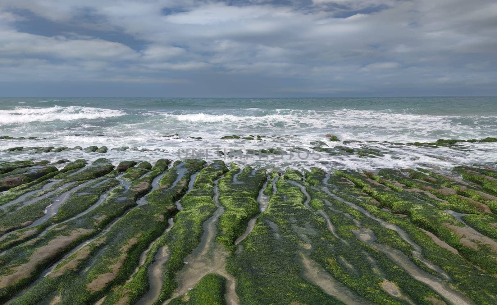 The Laomei Green Stone Trough is located in Shimen District on the North Coast, Every April and May, because the northeast monsoon slowly weakens, the local rock trough scientific name: tidal trench and sea erosion trench is covered with a large green seaweed