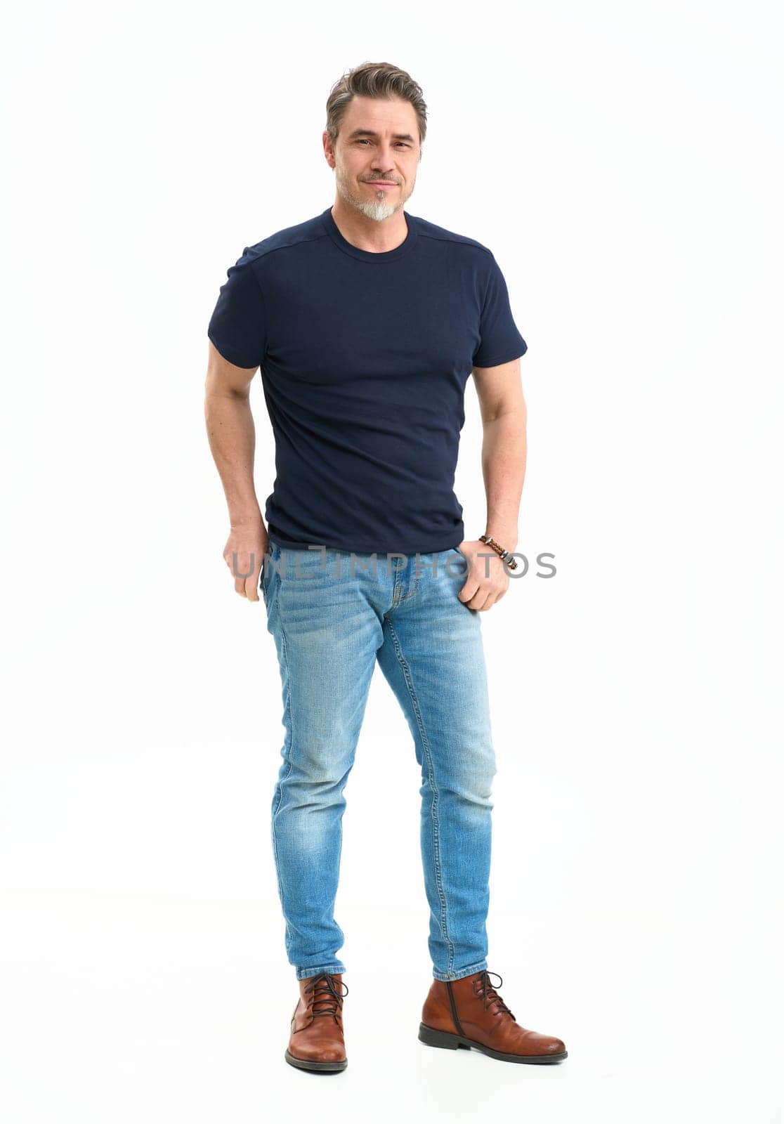 Middle age casual man in jeans and t-shirt. Mid adult, mature age man, happy smiling. Full length portrait isolated on white.