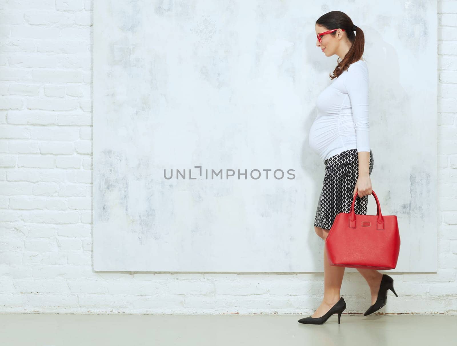Fashion portrait of pregnant businesswoman - pregnant woman in business casual.