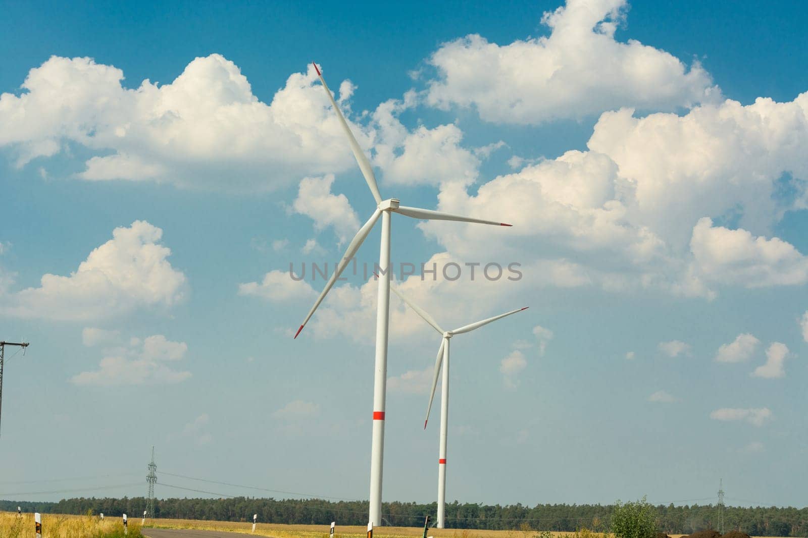 Sustainable green energy. Electric windmill generators in the sunrise