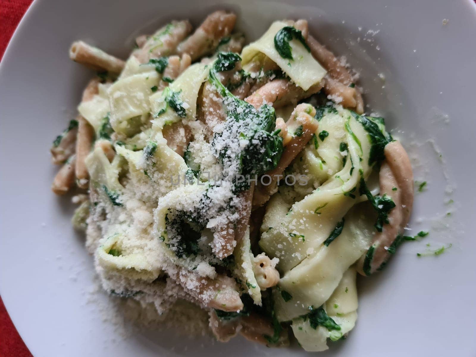 Pasta bolognese. Traditional italian dish of pasta with tomato and meat mince sauce served in a plate with parmesan cheese and thyme, top view