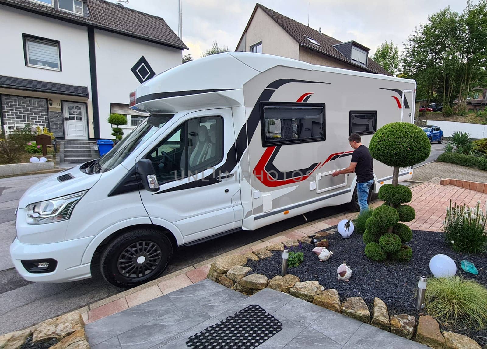 Man standing near motorhome getting ready to travel for family vacation travel, vacation trip in motorhome motorhome, caravan vacation.