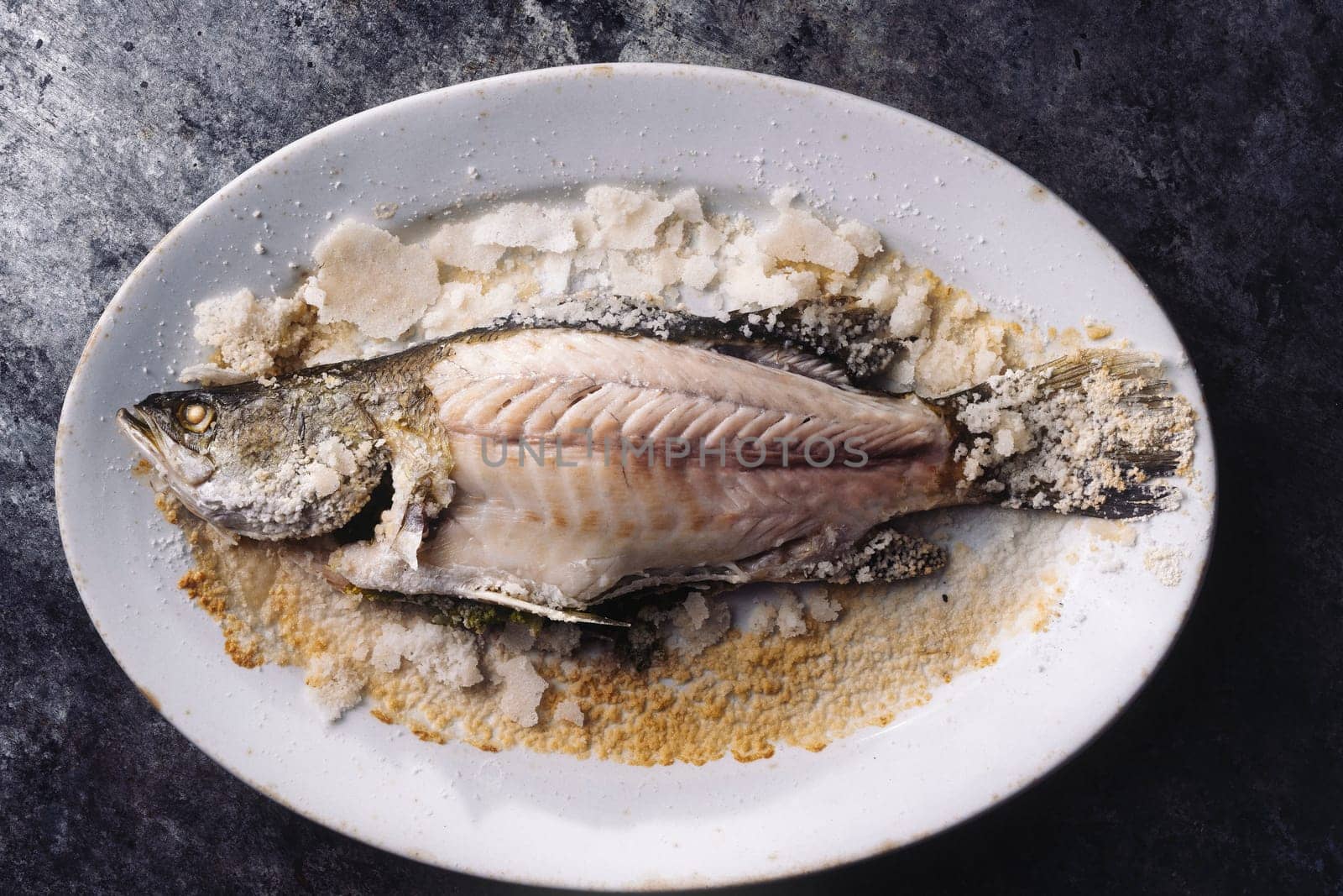 close up of sicilian italiansalt baked seabass fish