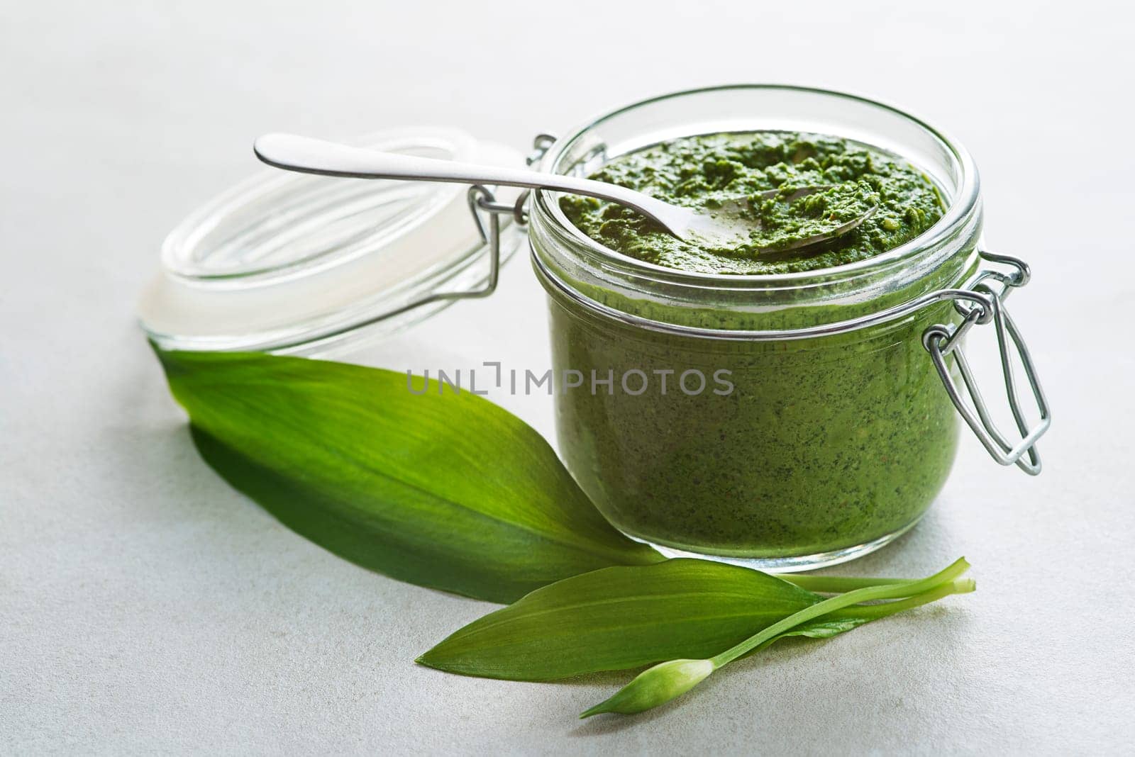 Fresh ramson or wild garlic pesto close up. Healthy spring food concept