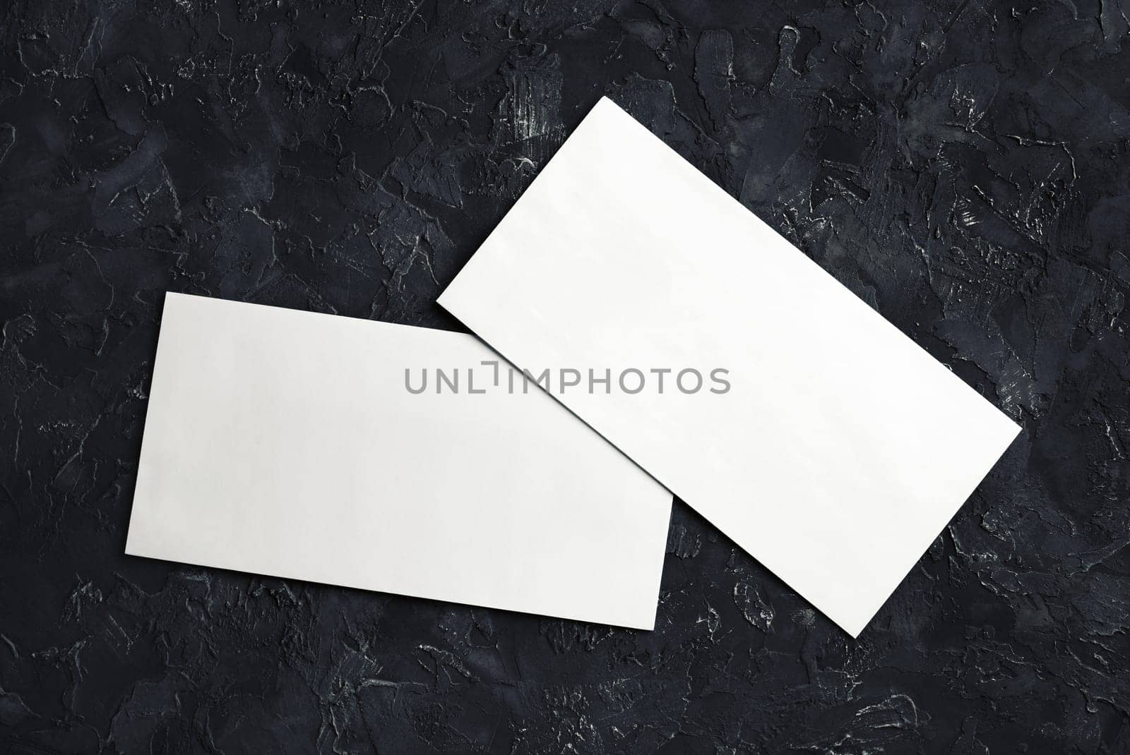 Photo of blank white paper envelopes. Template for branding identity. Top view.